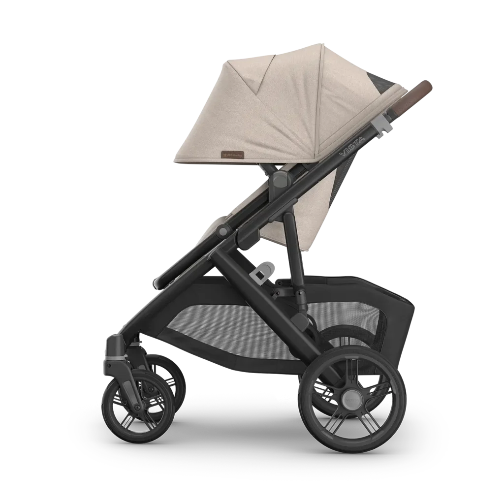 UPPAbaby Vista V3 pushchair in Ada (Sandstone Mélange) with carbon frame and chestnut leather handlebar, side view with forward-facing seat and large shopping basket